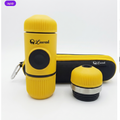 Yellow Luwak portable coffee maker with a matching black and yellow carrying case and a detached yellow lid, shown on a white background.